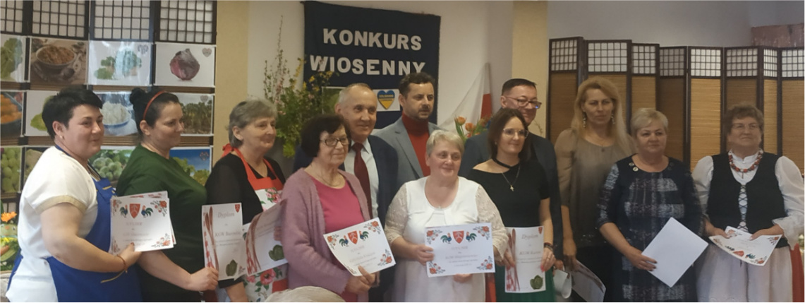 Nagrodzone zostały wszystkie koła gospodyń wiejskich Panie z nagrodzonych kół gospodyń wiejskich pozują do zdjęcia z dyplomami. Wśród nich są mężczyźni, którzy wręczali nagrody.